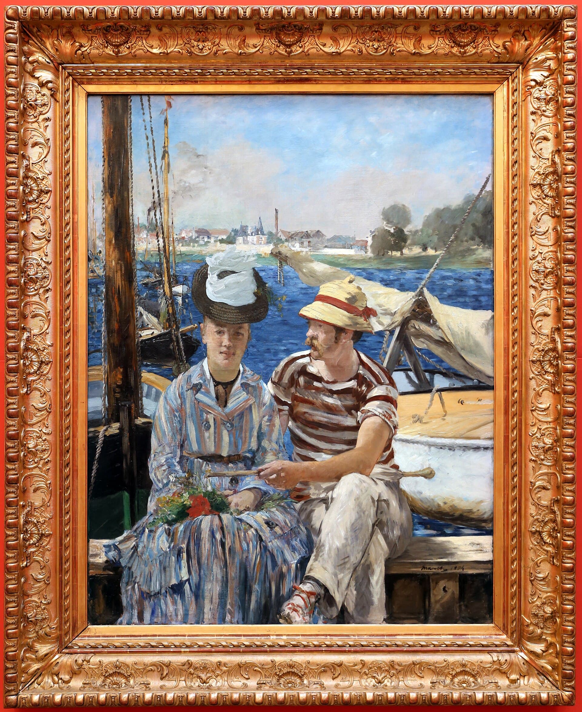 A man and woman in summer clothes sit side by side on the bank of the Seine, boats and masts behind them.