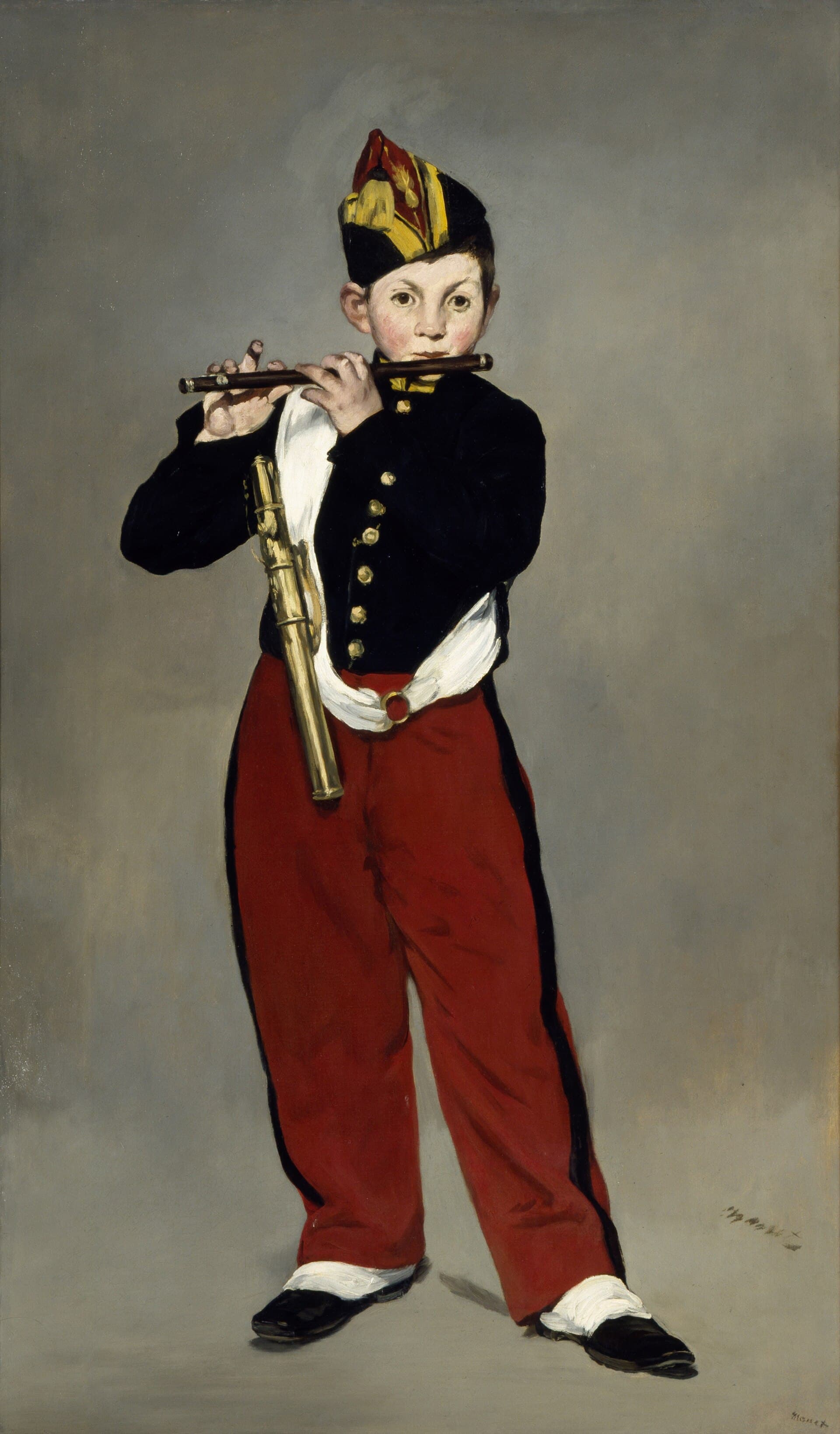 A boy in a military bandsman’s uniform playing a fife against a flat, undefined background.